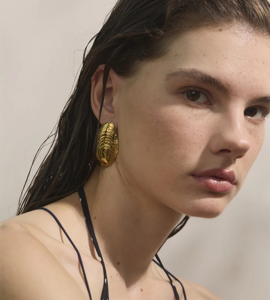 Statement gold color big stud earrings - product image