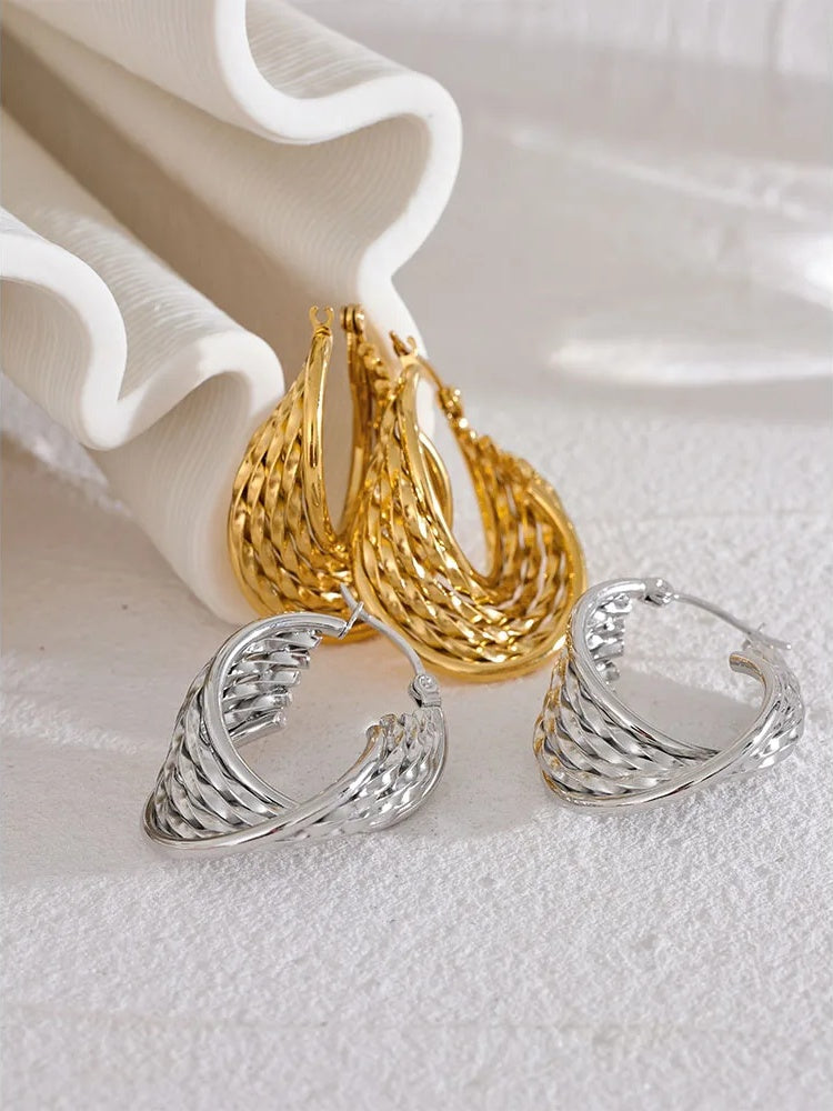 Twisted hollow hoop contemporary statement earrings - product image