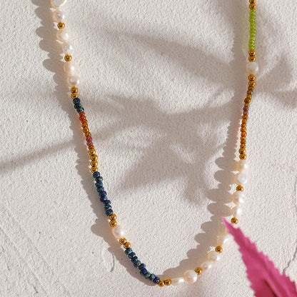 Necklace with multicolored beads on a textured white surface