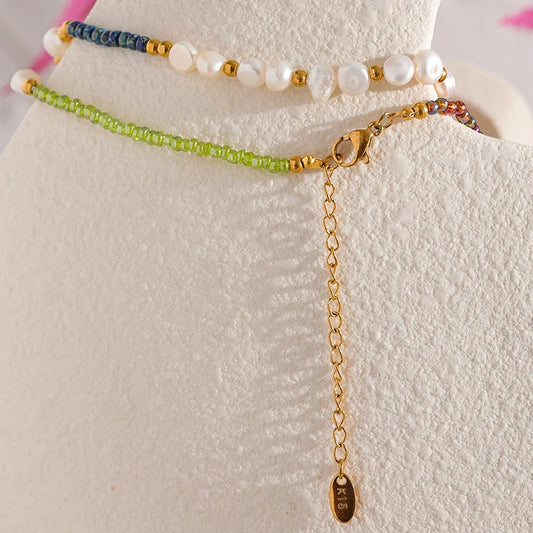 Set of beaded bracelets on a white stand with a floral background