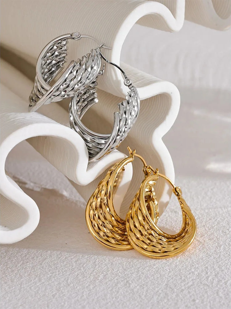 Twisted hollow hoop contemporary statement earrings - product image