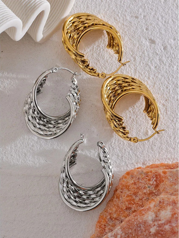 Twisted hollow hoop contemporary statement earrings - product image