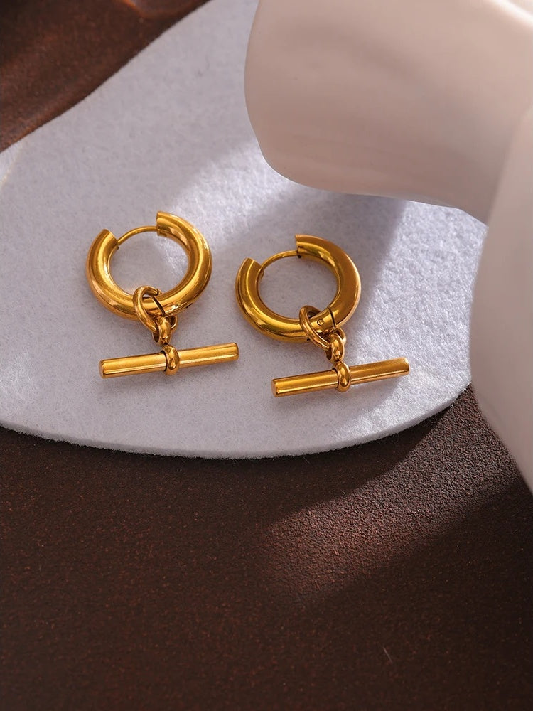 Unusual contemporary statement gold color huggie earrings - product image