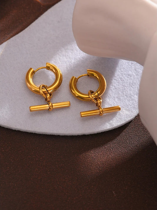 Unusual contemporary statement gold color huggie earrings - product image