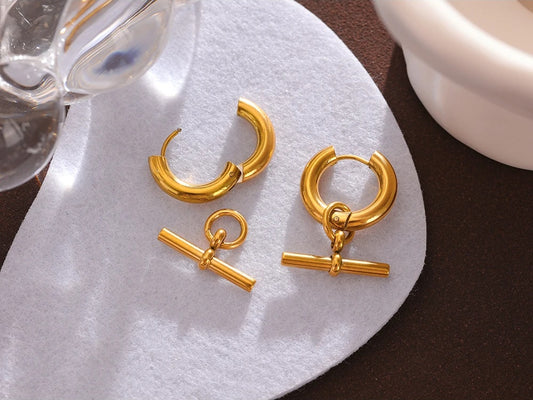 Unusual contemporary statement gold color huggie earrings - product image