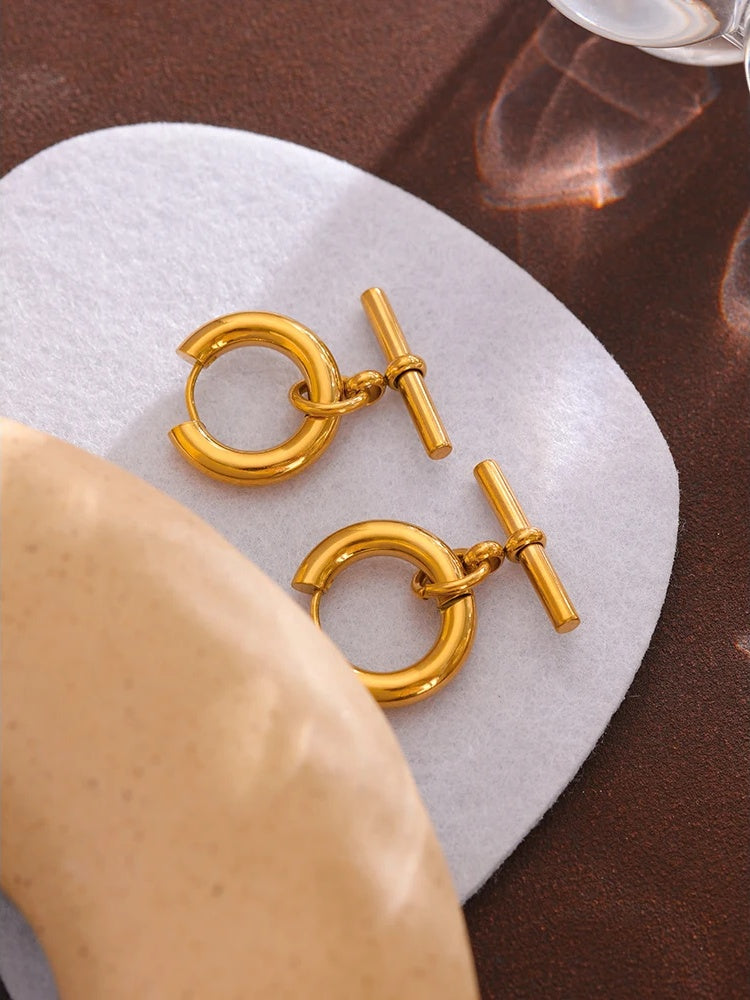 Unusual contemporary statement gold color huggie earrings - product image